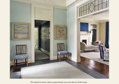 “We wanted to create a place to pause before you enter the rest of the house, which is wide open to the river,” Gissler says. He did that by lavishing as much attention on the foyer as on any other part of the house. A pair of eye-catching 1940s JOHAN TAPP CHINESE CHIPPENDALE–style chairs echo the mullions in the transom window and the handrail surrounding the double-height space. The designers painted the hallway from the foyer to the kitchen a very deep blue. Dark surfaces tend to recede, they note, which makes the narrow space feel wider than it is. The inky walls are covered with vintage celestial prints, differentiating the hallway from the otherwise very terrestrial setting.
