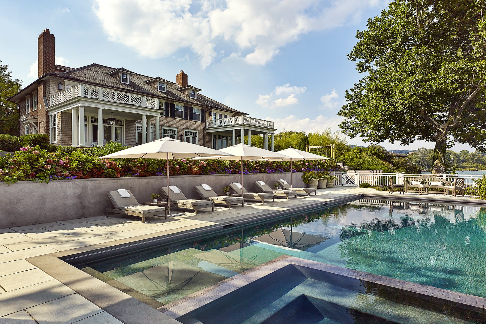 Chiseled into the sloping terrain between the main house and the Hudson River, the newly constructed terrace with its infinity edge pool and cabana provides a superb respite from the bustling streets of New York City, less than an hour away.
