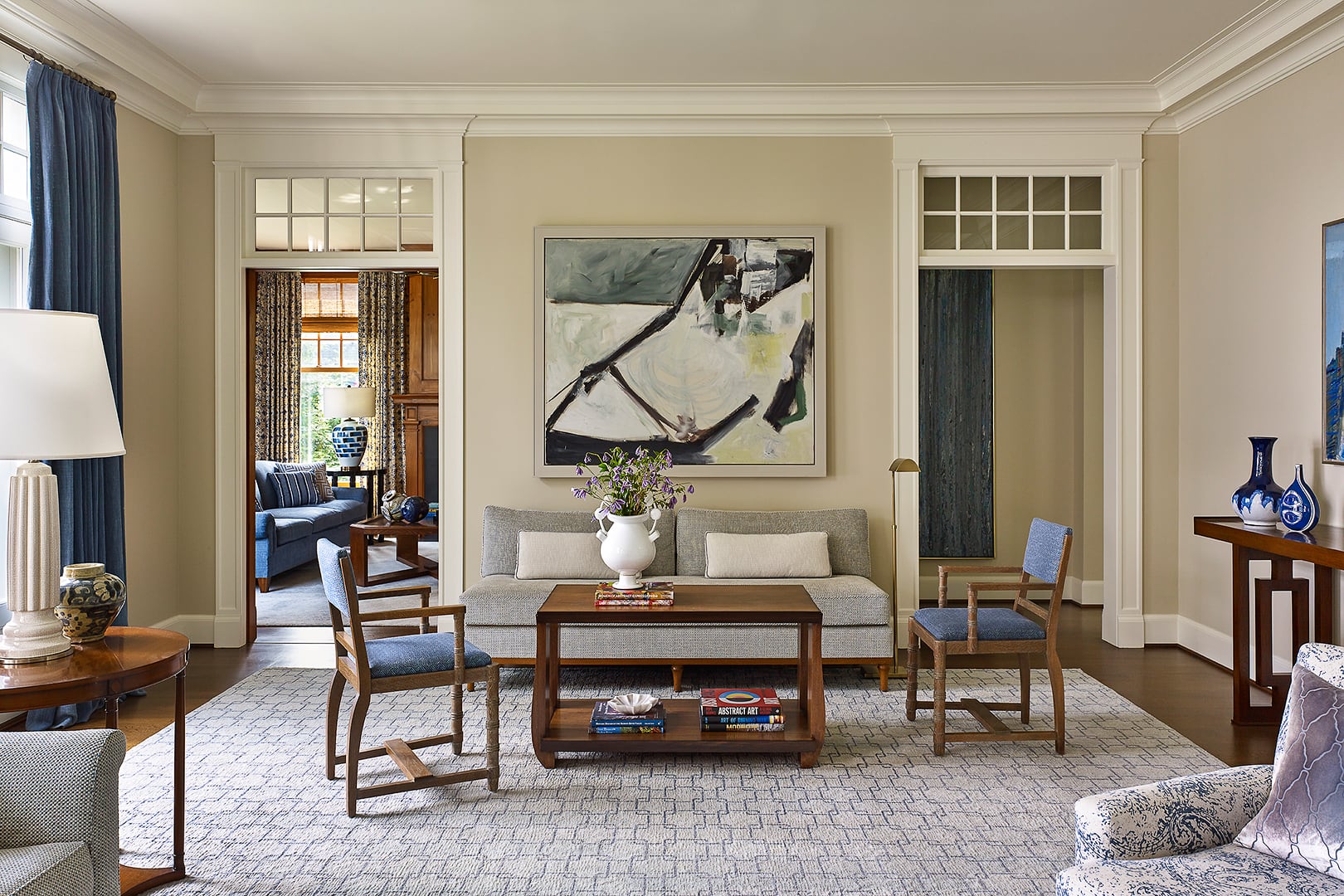 To one side of the living room, en route to the paneled library, a second seating area invites casual conversation with its armless sofa. The coffee table and chairs are French, with silhouettes establishing a note of continental modernity. Completing the tableau is The Studio, a 1952 canvas by female Abstract Impressionist Yvonne Thomas, who has garnered considerable attention in the years since her death.