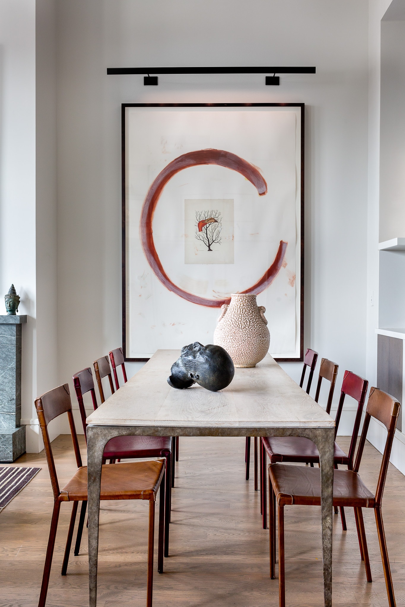 The elevator opens directly into the Dining Room where the large work on paper by artist Julian Schnabel holds court. The delicate lines of the steel and leather chairs and the steel and light wood table create a casual but chic first impression.